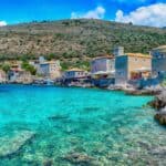 Küstendorf Limeni in Lakonien auf dem Peloponnes in Griechenland mit traditionellen Steinhäusern und kristallklarem türkisblauem Meer an einer felsigen Buch